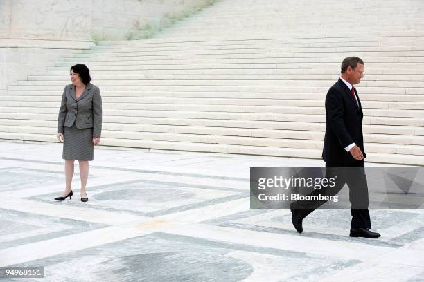Supreme Court Chief Justice John Roberts, right, departs after posing for photos with Justice Sonia Sotomayor following Sotomayor's taking a...
