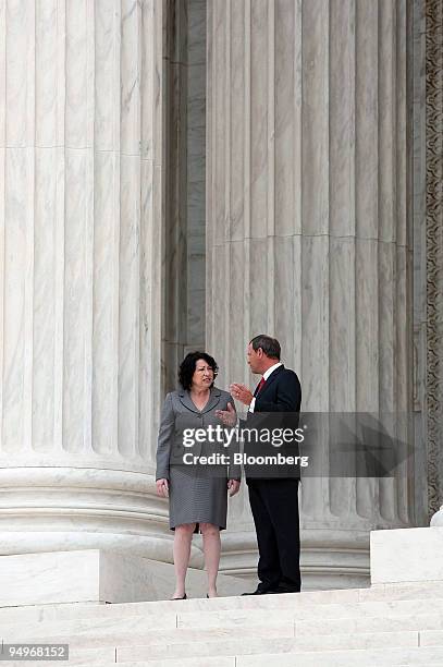 Supreme Court Justice Sonia Sotomayor, left, speaks with Chief Justice John Roberts, after taking a ceremonial oath of office in Washington, D.C.,...