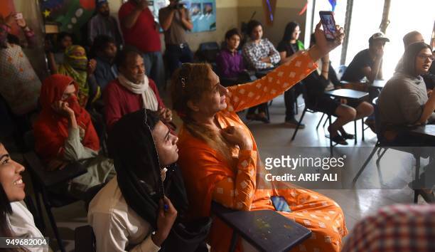 Pakistani students take a selfie in a class on the first day of the first transgender school in Lahore on April 21, 2018. - The school, 'The Gender...