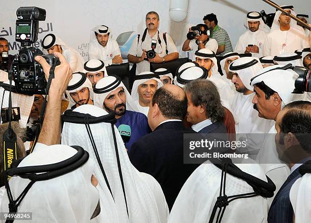 Sheikh Mohammed Bin Rashid Al Maktoum, Dubai's ruler and vice president of the United Arab Emirates, center left in blue, speaks to the media at the...