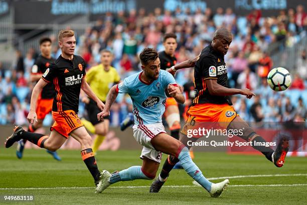 Brais Mendez of Celta de Vigo competes for the ball with Geoffrey Kondogbia of Valencia CF during the La Liga match between Celta de Vigo and...