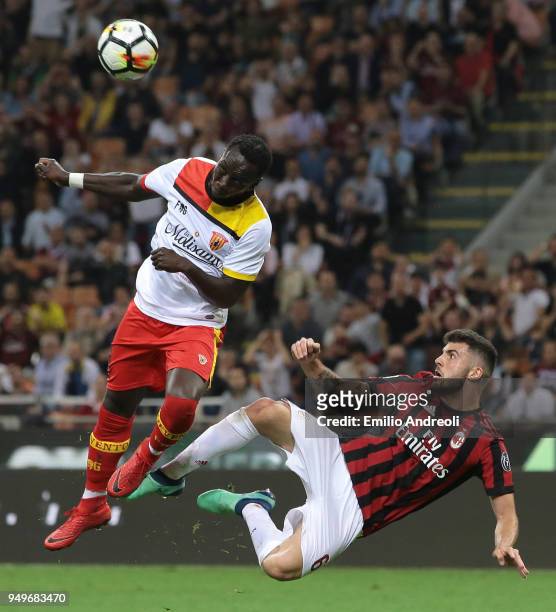 Bacary Sagna of Benevento Calcio jumps for the ball against Patrick Cutrone of AC Milan during the serie A match between AC Milan and Benevento...