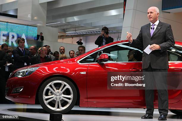 Carl-Peter Forster, General Motors Vice President and President of GM Europe, speaks next to an Opel Astra automobile on the first press day of the...