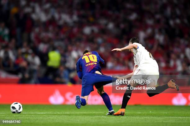Lionel Messi of Barcelona is pulled down by his shorts by Sevilla's Sergio Escudero during the Spanish Copa del Rey match between Barcelona and...
