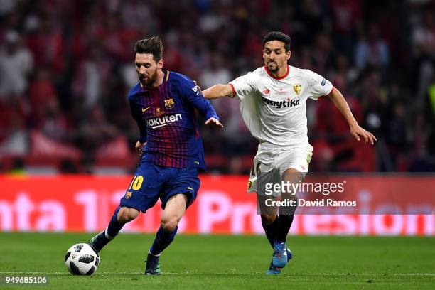 Lionel Messi of Barcelona looks to get away from Jesus Navas of Sevilla during the Spanish Copa del Rey match between Barcelona and Sevilla at Wanda...