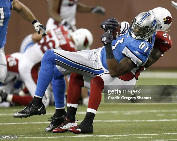 Calvin Johnson of the Detroit Lions is tackled after a first quarter catch by Antrel Rolle of the Arizona Cardinals on December 20, 2009 at Ford...