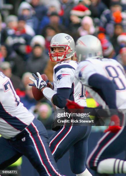 Tom Brady of the New England Patriots looks at Randy Moss just before throwing the ball to Moss against the Buffalo Bills at Ralph Wilson Stadium on...