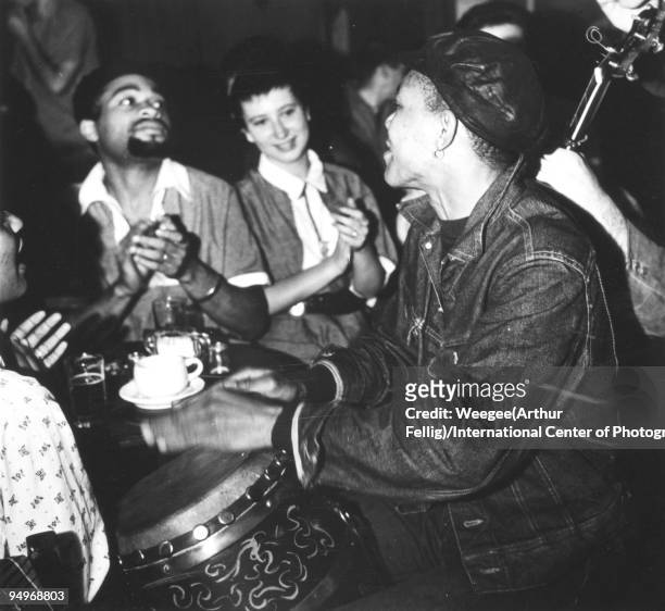 Musicians, playing banjo and bongo, perform in a Greenwich Village bar or cafe, New York, 1956.