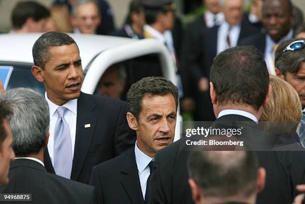 President Barack Obama, left, stands with Nicolas Sarkozy, France?s president, center, after the family photo at the G8 summit in L?Aquila, Italy, on...