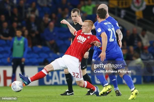 Ben Watson of Nottingham Forest is challenged by Craig Bryson and Aron Gunnarsson of Cardiff City during the Sky Bet Championship match between...