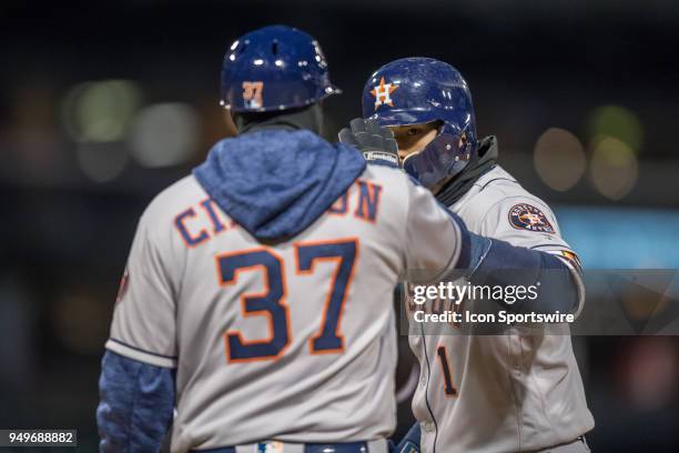 Houston Astros shortstop Carlos Correa celebrates with Houston Astros first base coach Alex Cintron during a game between the and the Houston Astros...