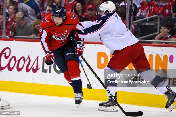 Columbus Blue Jackets defenseman Zach Werenski holds Washington Capitals right wing Alex Chiasson in the first period during game five of the first...