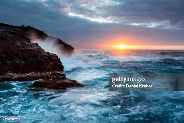 surf, rocky coast with foaming waves at sunset, puerto de la madera, tacoronte, tenerife, canary islands, spain - madera stock pictures, royalty-free photos & images