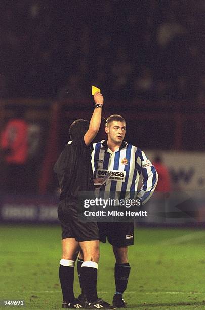 Referee Alan Wiley books a Dagenham & Redbridge player during the AXA sponsored FA Cup 3rd round match against Charlton Athletic played at The...