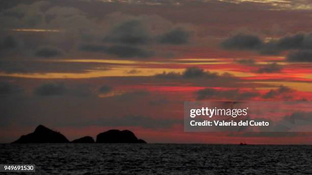 tijucas islands on colorful horizon from ipanema - valeria del cueto stock pictures, royalty-free photos & images