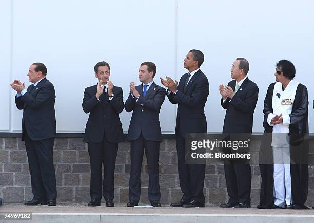 Silvio Berlusconi, Italy's prime minister, far left, applauds with, left to right, Nicolas Sarkozy, France's president, Dmitry Medvedev, Russia's...