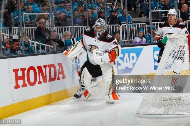 John Gibson of the Anaheim Ducks clears the puck against the San Jose Sharks in Game Three of the Western Conference First Round during the 2018 NHL...