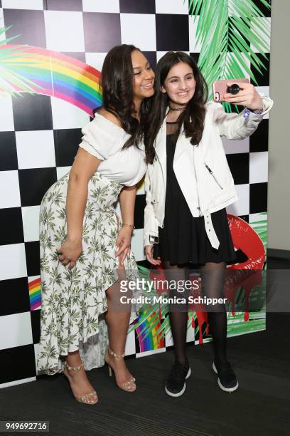 Nia Sioux poses with a fan at a Meet & Greet during Beautycon Festival NYC 2018 - Day 1 at Jacob Javits Center on April 21, 2018 in New York City.