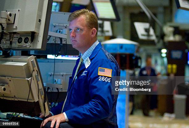 Trader looks at a monitor while working on the floor of the New York Stock Exchange in New York, U.S., on Monday, July 13, 2009. U.S. Stocks rallied,...