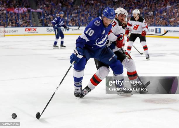 Miller of the Tampa Bay Lightning fights off a check by Marcus Johansson of the New Jersey Devils in the second period of Game Five of the Eastern...