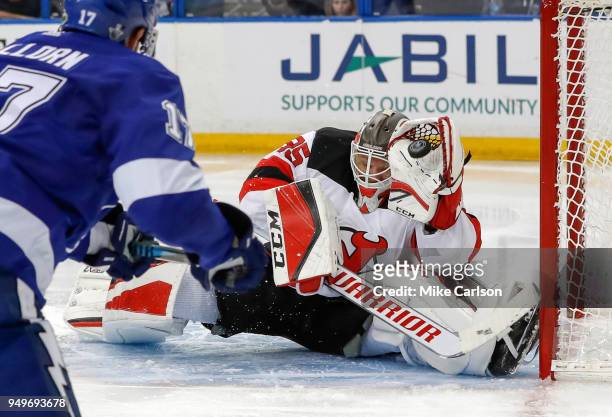 Cory Schneider of the New Jersey Devils makes a save on Alex Killorn of the Tampa Bay Lightning in the second period of Game Five of the Eastern...