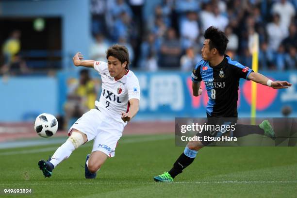 Atsuto Uchida of Kashima Antlers and Hiroyuki Abe of Kawasaki Frontale compete for the ball during the J.League J1 match between Kawasaki Frontale...