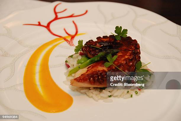 Polipo," a plate of grilled octopus, insalata di riso, fava and yellow tomato is shown at Marea restaurant in New York, U.S., on Monday, July 13,...