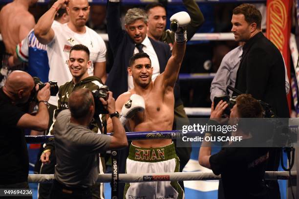 Britain's Amir Khan celebrates defeating Canada's Phil Lo Greco in their Super-Welterweight contest at the Echo Arena in Liverpool, northern England,...