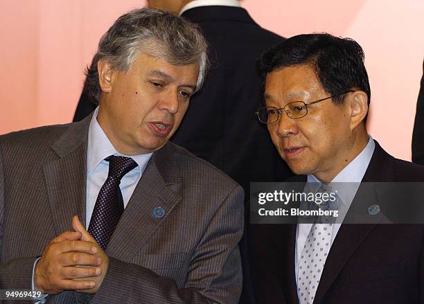 Carlos Furche Guajardo, Chile's head of economic affairs, left, chats with Chen Deming, China's minister for commerce, at the Asia-Pacific Economic...