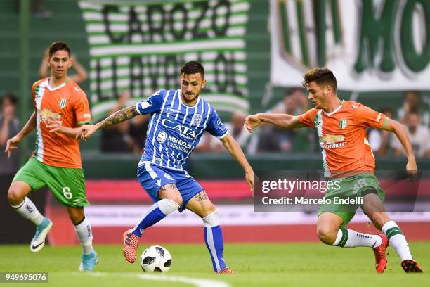 Angel Gonzalez of Godoy Cruz drives the ball against Adrián Sporle of Banfield during a match between Banfield and Godoy Cruz as part of Argentina...