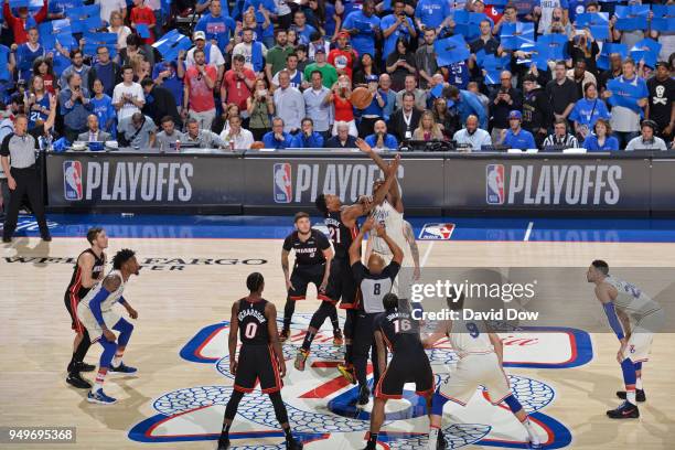 Hassan Whiteside of the Miami Heat and Amir Johnson of the Philadelphia 76ers reach for the jump ball to start game one of round one of the 2018 NBA...