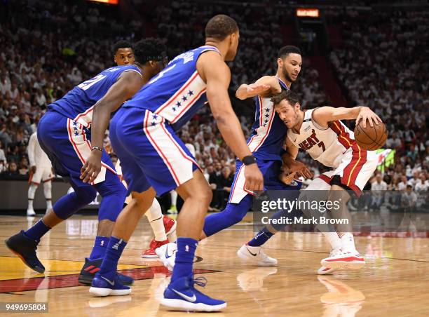 Justin Anderson, Joel Embiid and Ben Simmons of the Philadelphia 76ers guard Goran Dragic of the Miami Heat in the third quarter during Game Four of...
