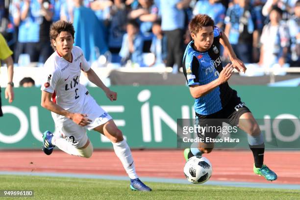 Atsuto Uchida of Kashima Antlers and Shintaro Kurumaya of Kawasaki Frontale compete for the ball during the J.League J1 match between Kawasaki...