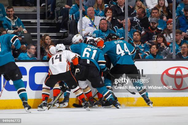 Adam Henrique of the Anaheim Ducks battles for the puck against Justin Braun and Marc-Edouard Vlasic of the San Jose Sharks in Game Three of the...