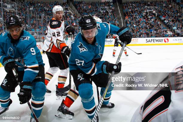 Evander Kane and Joonas Donskoi of the San Jose Sharks skate after the puck against Josh Manson of the Anaheim Ducks in Game Three of the Western...