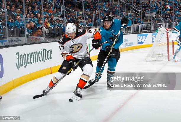Rickard Rakell of the Anaheim Ducks skates after the puck against Justin Braun of the San Jose Sharks in Game Three of the Western Conference First...