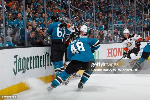 Rickard Rakell of the Anaheim Ducks skates against Justin Braun and Tomas Hertl of the San Jose Sharks in Game Three of the Western Conference First...