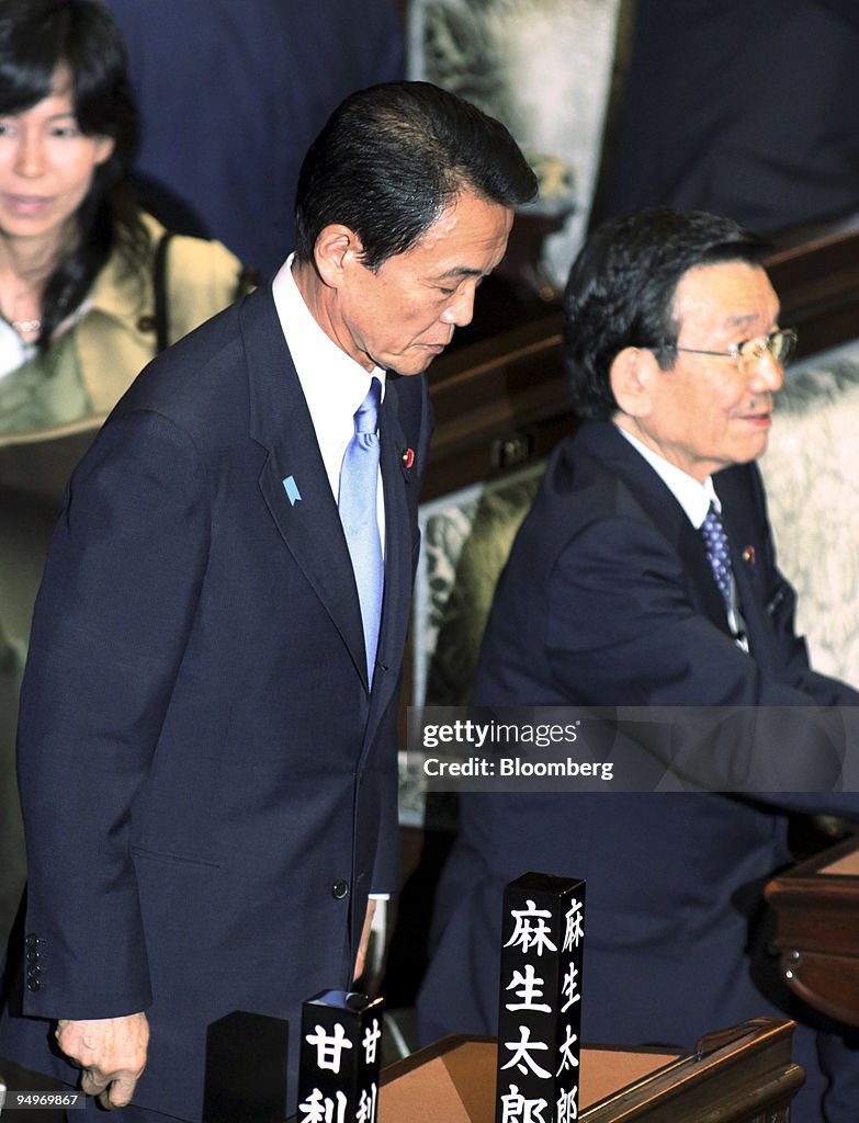 Taro Aso, Japan's prime minister, left, bows after arriving