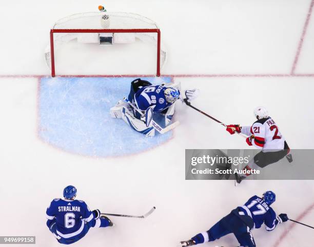 Goalie Andrei Vasilevskiy of the Tampa Bay Lightning makes a save against Kyle Palmieri of the New Jersey Devils in Game Five of the Eastern...