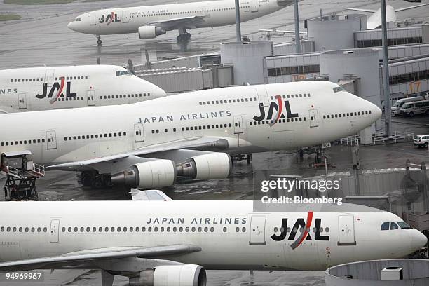 Japan Airlines Corp. Airplanes are parked at Haneda Airport in Tokyo, Japan, on Tuesday, July 21, 2009. American Airlines, the world's second-largest...