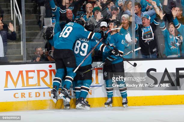 Logan Couture of the San Jose Sharks celebrates with teammates after scoring against the Anaheim Ducks in Game Three of the Western Conference First...