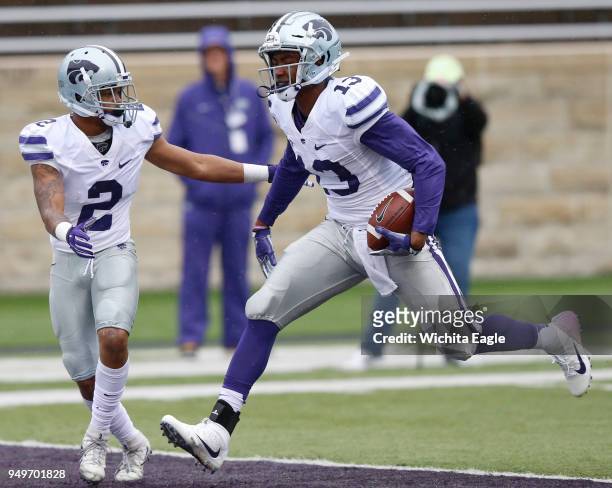 Kansas State wide receiver Chabastin Taylor scores his first touchdown, with wide receiver Isaiah Harris joining in on the celebration, during the...