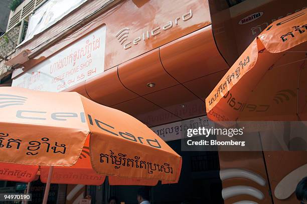 The Cellcard mobile logo is displayed outside of a shop in downtown Phnom Penh, Cambodia, on Friday, July 24, 2009. Cellcard, a pre-paid mobile phone...