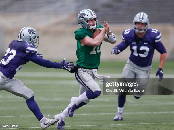 Kansas State quarterback Skylar Thompson tries to slip past purple defenders during the annual Spring Game at K-State in Manhattan, Kan., on...