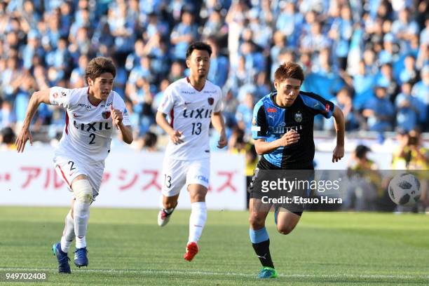 Atsuto Uchida of Kashima Antlers and Shintaro Kurumaya of Kawasaki Frontale compete for the ball during the J.League J1 match between Kawasaki...