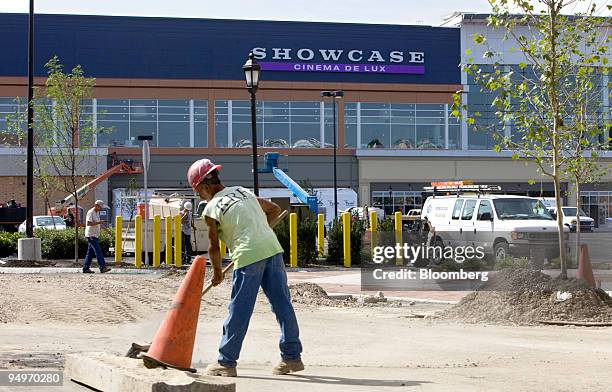 Showcase cinema complex, a brand of National Amusements Inc., stands in the background of construction workers in Dedham, Massachusetts, U.S., on...