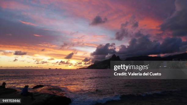 colorful rays in the twilight sky of rio - valeria del cueto stock pictures, royalty-free photos & images
