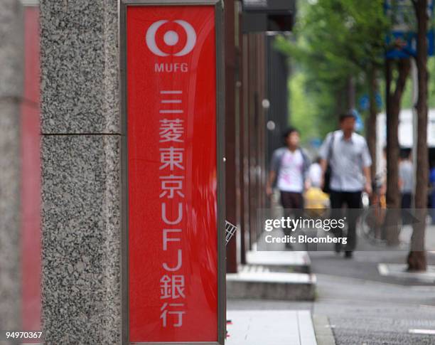 Pedestrians walk near a branch of Bank of Tokyo Mitsubishi UFJ in Tokyo, Japan, on Friday, July 31, 2009. Mitsubishi UFJ Financial Group Inc. Is...