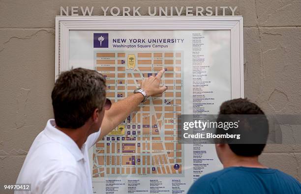 Prospective student Mark Hickey, right, and Mark Cullen look at a New York University campus map in New York, U.S., on Tuesday, July 28, 2009....
