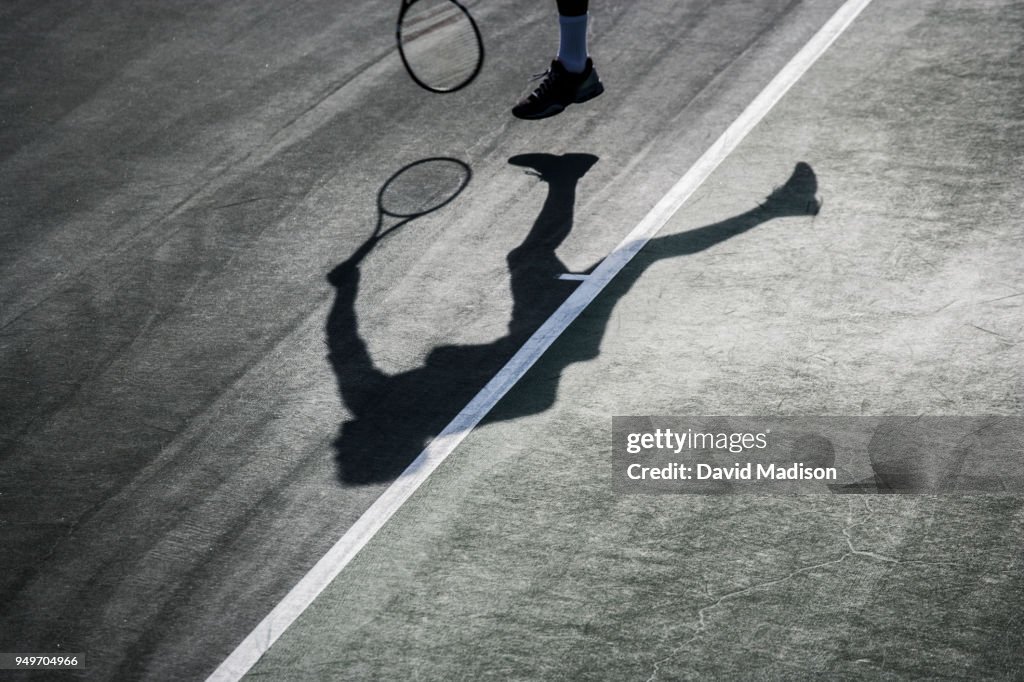 Tennis player and shadow
